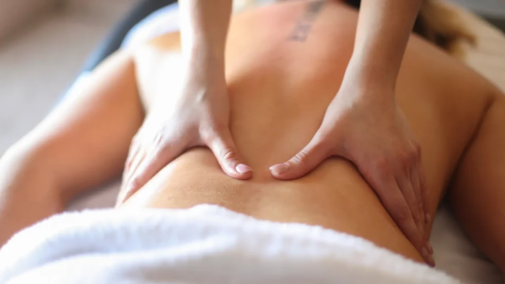 Adult massage therapist performing a sensual massage