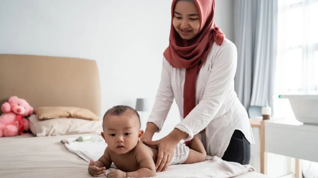 Baby receiving Asian massage from a Therapist