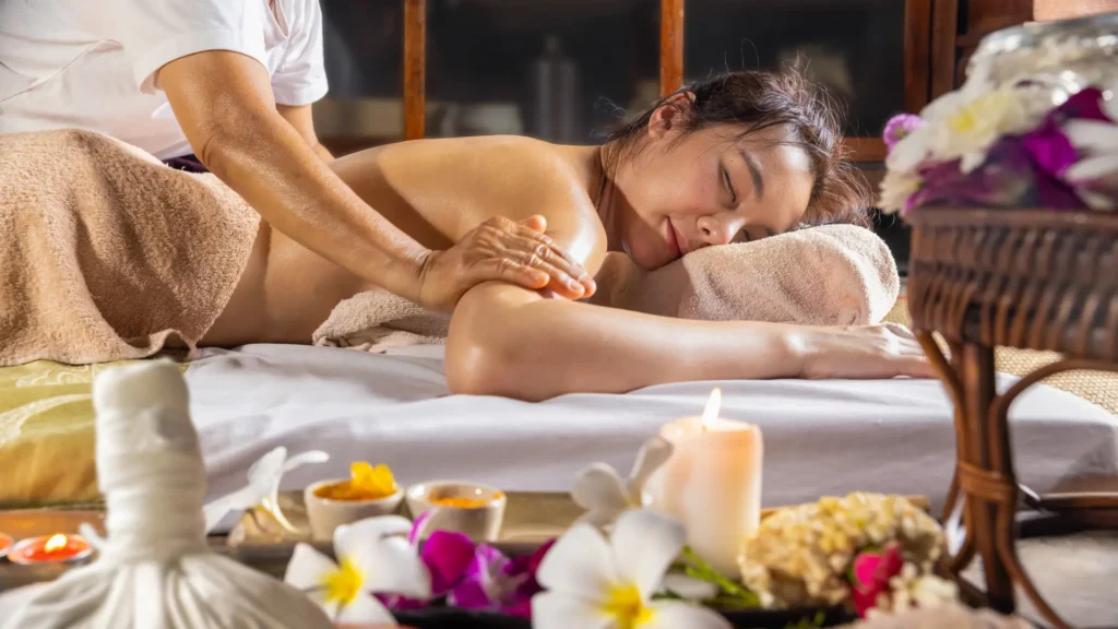 Woman lying down receiving shiatsu massage on her back