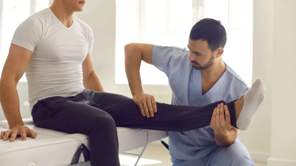 male massage therapist providing focused massage treatment