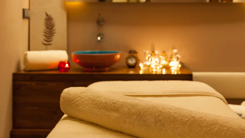 nuru-massage-room-with-dim-lighting-and-soft-bedding