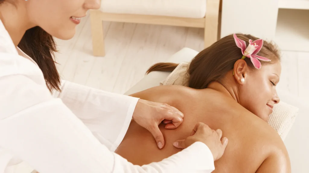 Female Therapist offering Targeted Back Massage to her Female Client