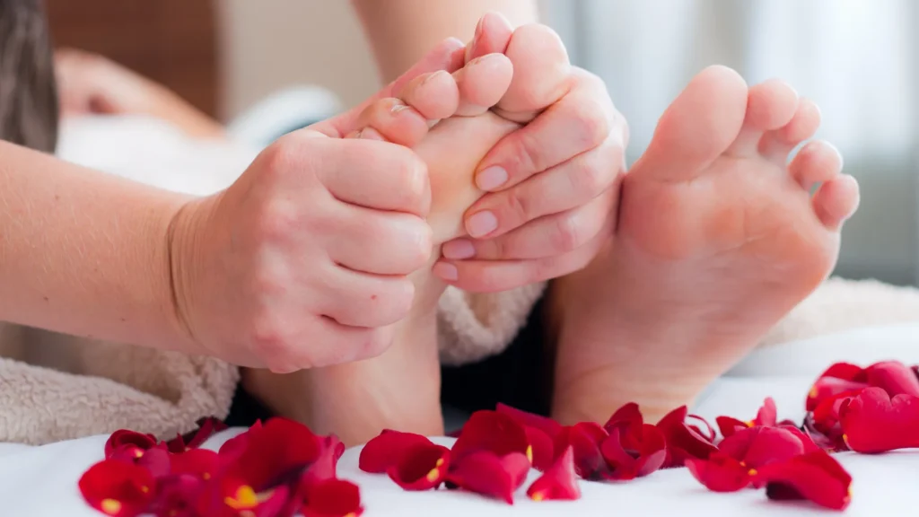Female San Antonio Foot Massage specialist massaging a Male's Feet for Reflexology